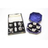 Two cased sets of silver cruets
