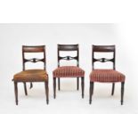 A set of eight Regency mahogany and ebony strung sabre-leg dining chairs
