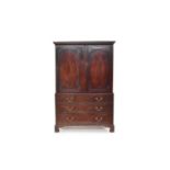 A George III mahogany linen press, converted to a wardrobe