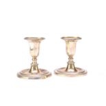 A pair of George III dwarf silver candlesticks