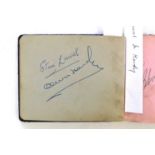 STAN LAUREL AND OLIVER HARDY autographs in an album.