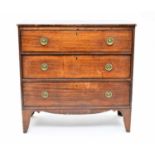 An early 19th century rectangular mahogany chest of three long drawers