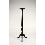 An Edwardian mahogany torchere stand