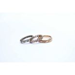 A 9ct band and two eternity rings