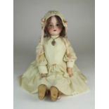 A Simon & Halbig doll with additional dress