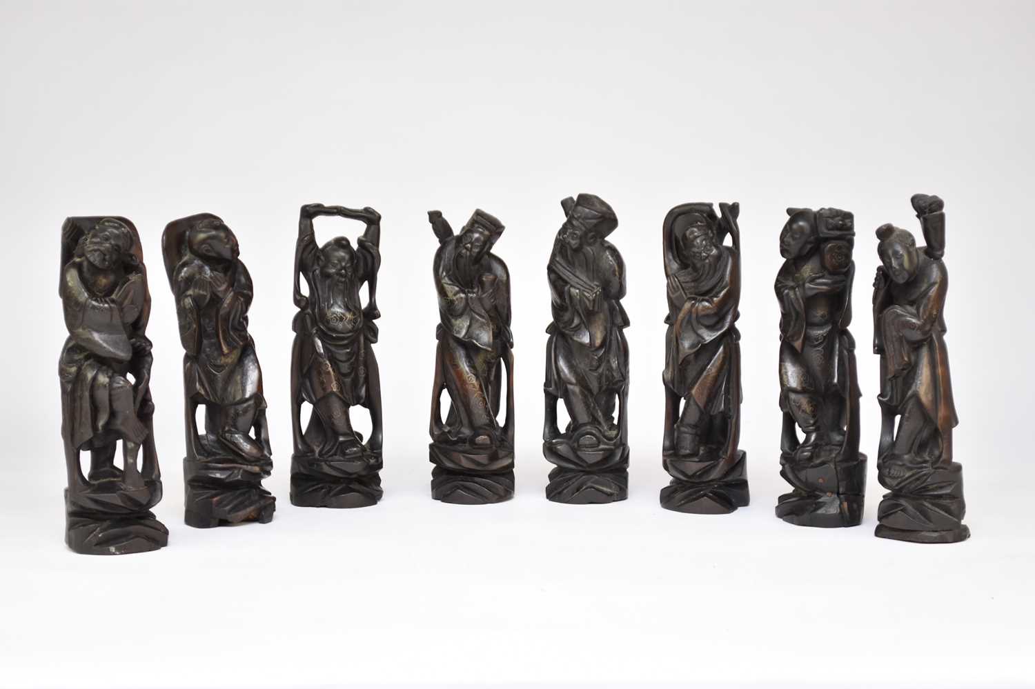 A set of Chinese carved and inlaid rosewood figures of the eight immortals