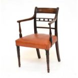 A George IV mahogany elbow chair covered in hide and a standard chair (2)