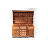 A 19th century oak break-front dresser and associated rack