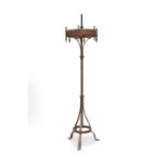 A 19th century wrought iron and brass candle stand