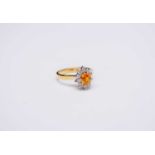 An 18ct gold yellow sapphire and diamond oval cluster ring