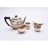 A silver teapot, two silver cream jugs and a silver mug