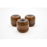 A set of three lignum vitae horse tethering weights