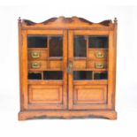 An Edwardian oak smokers cabinet