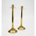 A pair of early 20th century brass candlesticks