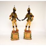 A pair of reproduction painted wood blackamoor table lamps