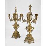 A pair of brass rococo revival five-branch candelabra