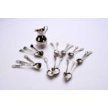 A collection of silver teaspoons and a cream jug