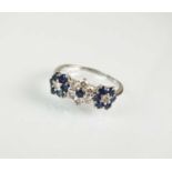 A sapphire and diamond floral cluster ring and earrings