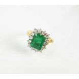An 18ct gold emerald and diamond cluster ring