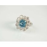 A platinum fancy vivid blue coloured diamond cluster ring