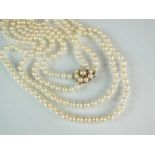 An Opera length two strand uniform cultured pearl necklace and a single cultured pearl earring