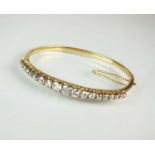 A late 19th century diamond hinged bangle