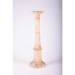 A white marble torchere stand