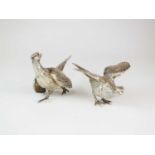 A pair of silver ornaments modelled as pheasants