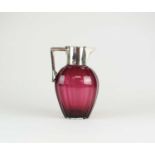 A Victorian silver mounted cranberry glass claret jug