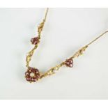 An early 20th century style 9ct gold garnet and and seed pearl necklace