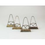 A set of four white metal Staffordshire knot menu holders