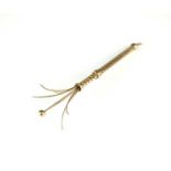 A 9ct gold swizzle stick