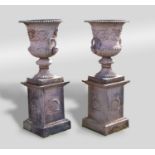 A good and impressive pair of cast iron campana urns and pedestals