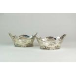 A pair of pierced silver dishes