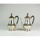 A faceted silver coffee pot and hot water jug