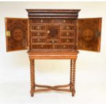 A William and Mary oyster veneered cabinet on a later stand