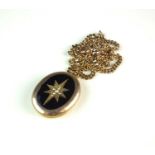 A late 19th century seed pearl and black enamel oval locket