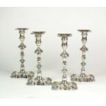 A near set of four cast silver candlesticks