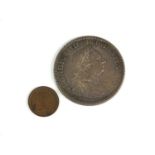 A George III silver dollar and a Victorian copper half farthing