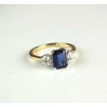 An 18ct gold three stone sapphire and diamond ring