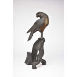 A Japanese bronze figure of an eagle perched on a branch