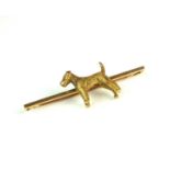 A yellow metal Terrier bar brooch