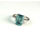 A three stone blue zircon and diamond ring