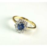 An 18ct gold sapphire and diamond cluster ring