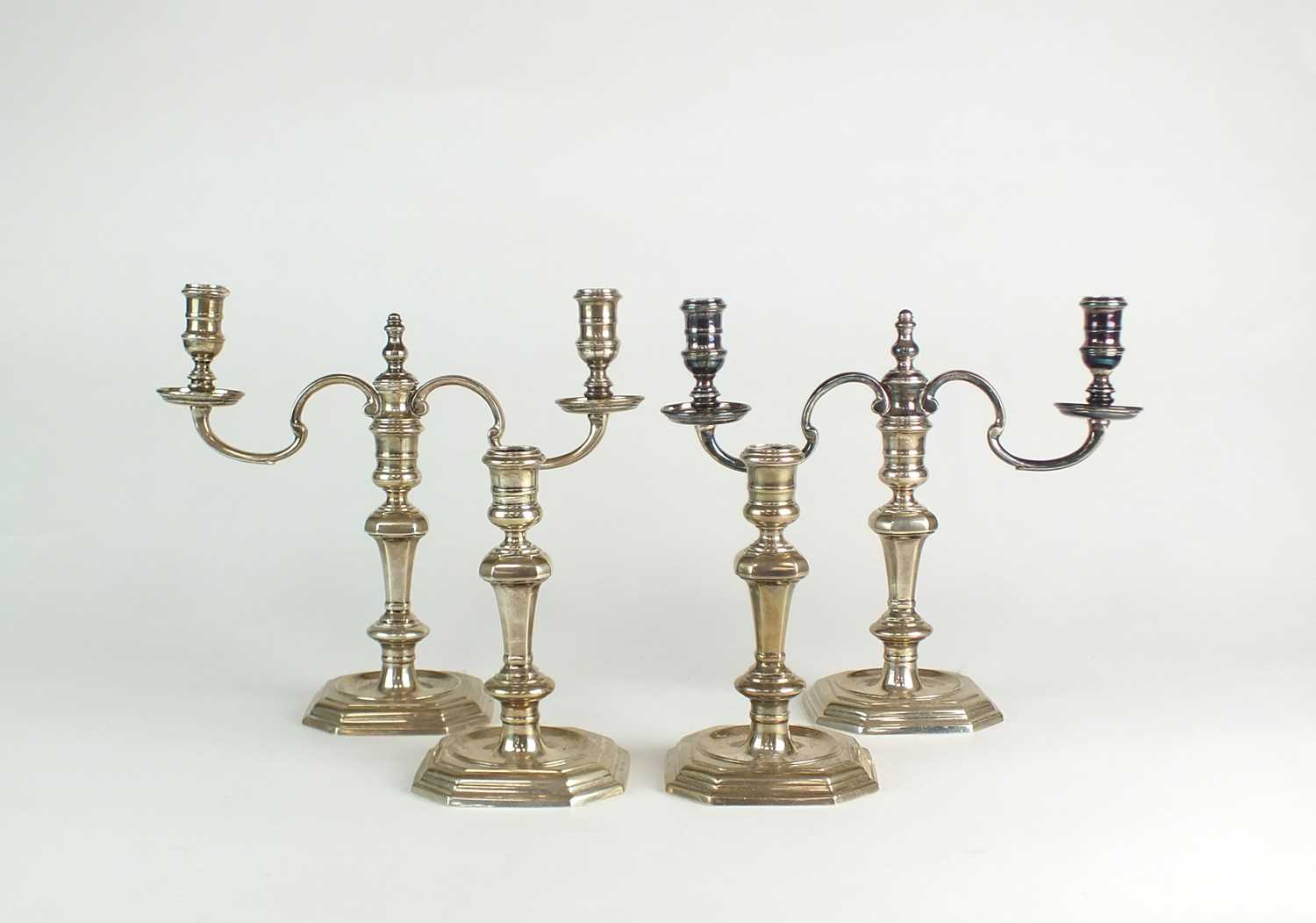 A set of four silver candlesticks