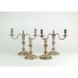 A set of four silver candlesticks