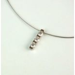 An 18ct white gold three stone diamond pendant on chain