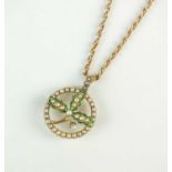 An early 20th century seed pearl and green enamel brooch/pendant on chain