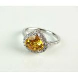 An 18ct white gold heart shaped yellow sapphire and diamond cluster ring