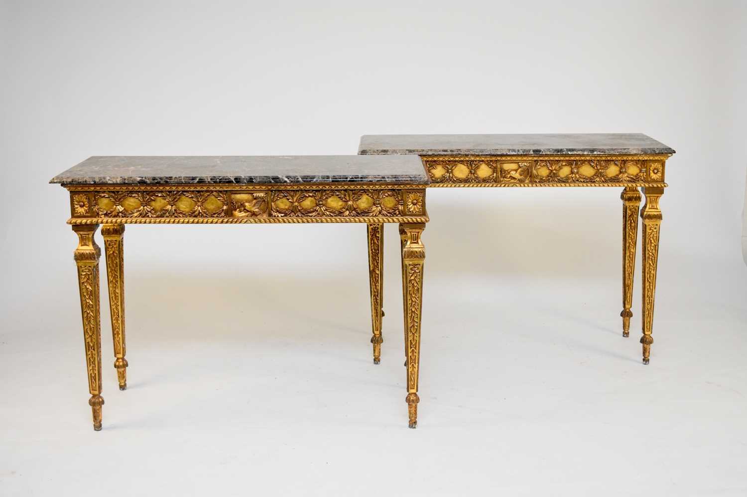 A pair of Louis XVI style marble-topped console tables